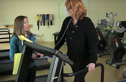 Woman on treadmill in rehab