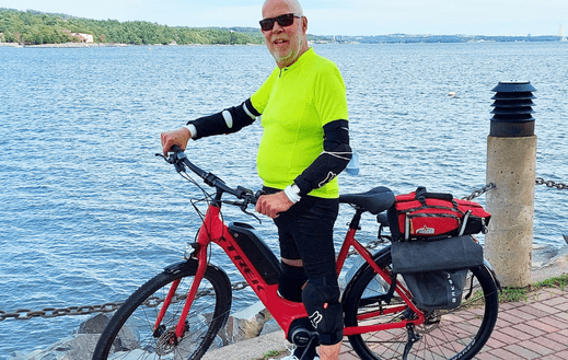 John Dennis on bike near the ocean