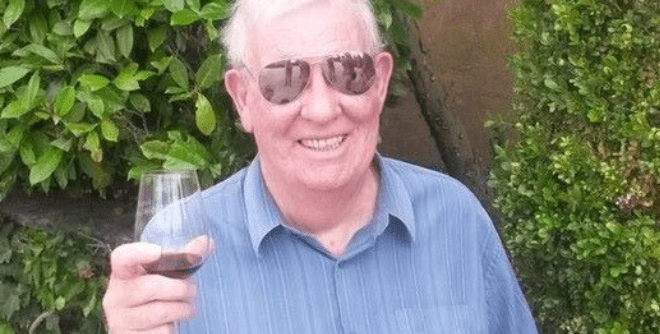 Robert Davidson holding a glass of wine