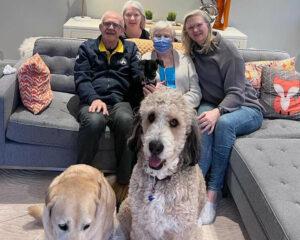 Members of the Hurding family gather for a photo just before Anne returns to the hospital on March 24. From right to left: Brian, Lorraine, Anne (with dog Lilly on her lap) and Suzanne. Camera-shy dog on left is Bear and Suzanne’s dog Sam is front-right.