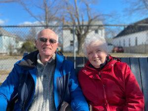 Dale and Carolyn enjoy the winter sunshine on a park bench.