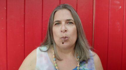 Woman breathing through a straw