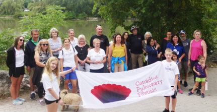 Group of people holding a CPFF banner in a park
