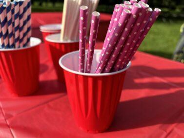 People breathing through a straw to see what its like to work hard to breathe for pucker up challenge